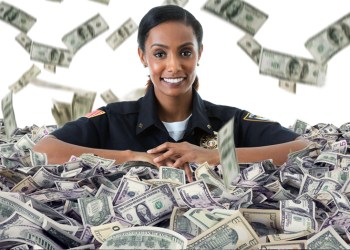 Female Hamptons Police Department officer in pile of cash with bills raining down