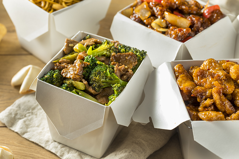 Spicy Chinese Take Out Food with Chopsticks and Fortune Cookies
