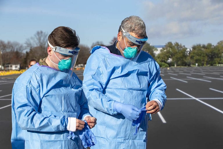 ASSISTANT DEAN FOR CLINICAL INTEGRATION JOSHUA MILLER, MD, MPH INSTRUCTS MEDICAL STAFF ON THE PROCEDURES TO TAKE IN SCREENING DRIVE UP PATIENTS AT THE COVID-19 DRIVE-THRU TESTING FACILITY. PHOTO BYSTONY BROOK UNIVERSITY HOSPITAL