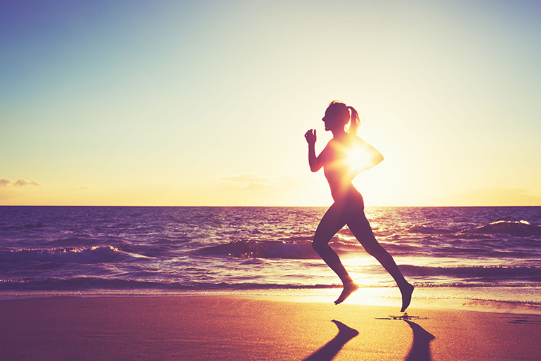 Woman Running on the Beach at Sunset