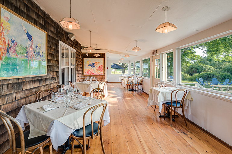 Old Stove Pub's indoor dining space, with picnic tables in the distance, Photo: Courtesy Starlet PR