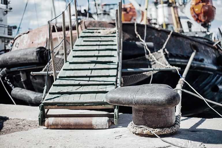 the ship is moored to a dock ladder rope chain 3