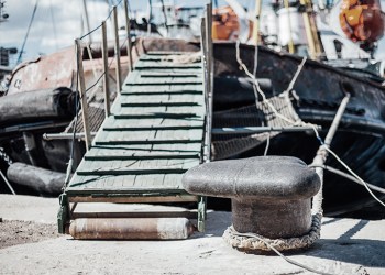 the ship is moored to a dock ladder rope chain 3