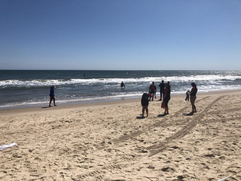 A POLICE TAPE CORDONED OFF AN AREA WHERE POLICE WERE LAUNCHING DIVERS AND JET SKIS TUESDAY AFTERNOON IN SEARCH OF THE MISSING SWIMMER.