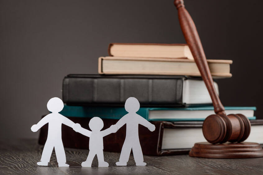 Paper people chain, books and judge's gavel. Law, family politics and gay marriage legalization.