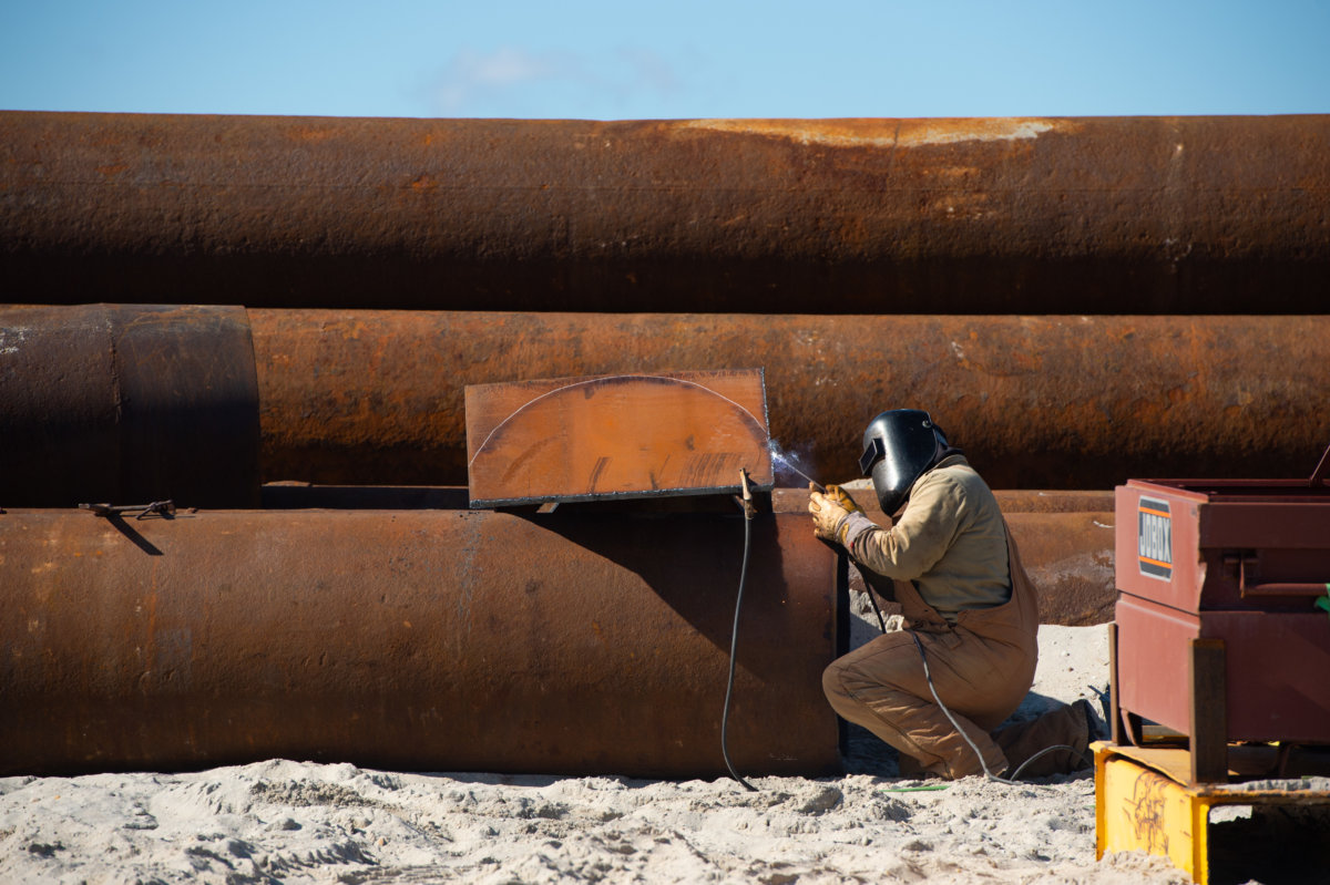 FIMP worker preps pipes during dredging project in the Hamptons
