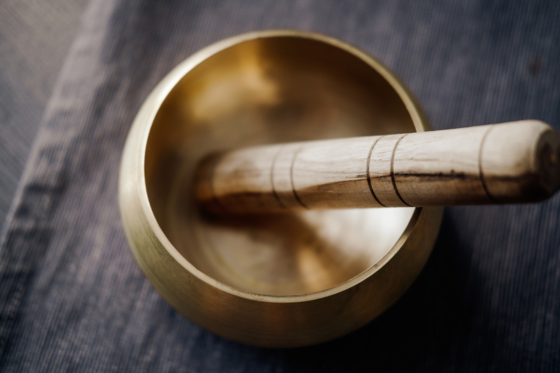 Bronze tibetan singing bowl with wooden stick. Sound healing, sound bath therapy in the Hamptons