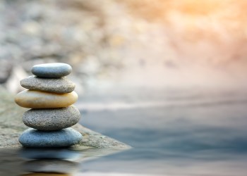 Balance stone with spa on river coast