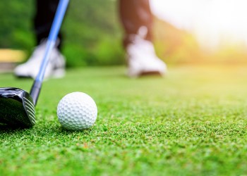 Close up golf ball on green grass