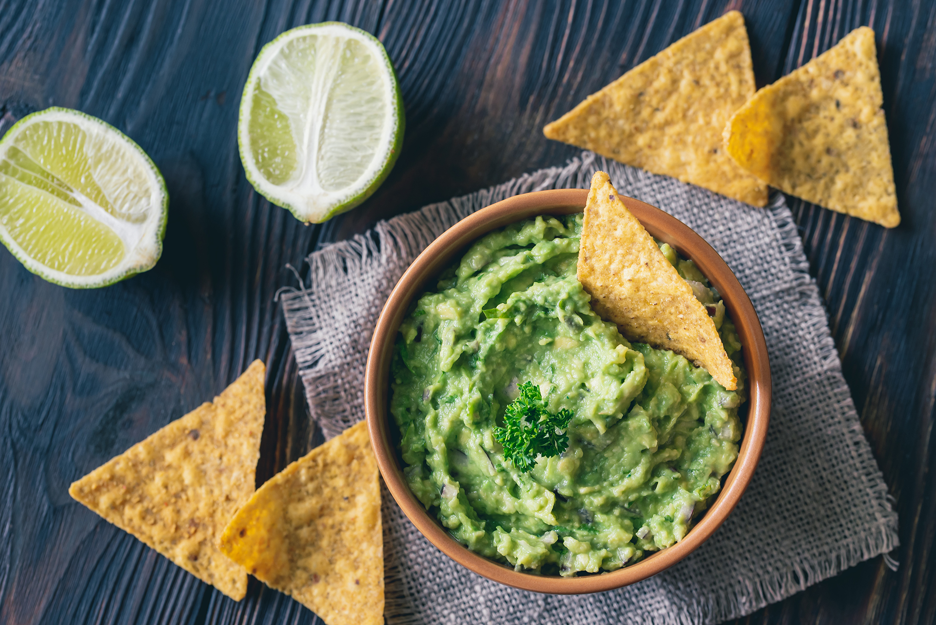 Bowl of guacamole with tortilla chips: top view