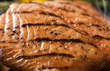 Close up of a grilled salmon filet on charcoal grill with asparagus, hot charcoal, fire and smoke. Please see my portfolio for other food and drink images.