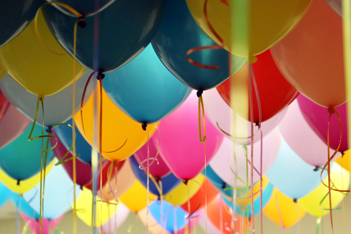 Helium balloons with ribbons in the office