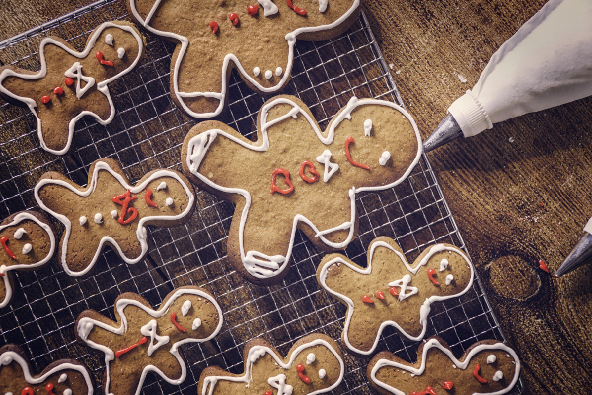 Decorating gingerbread Christmas Cookies with colorful icing