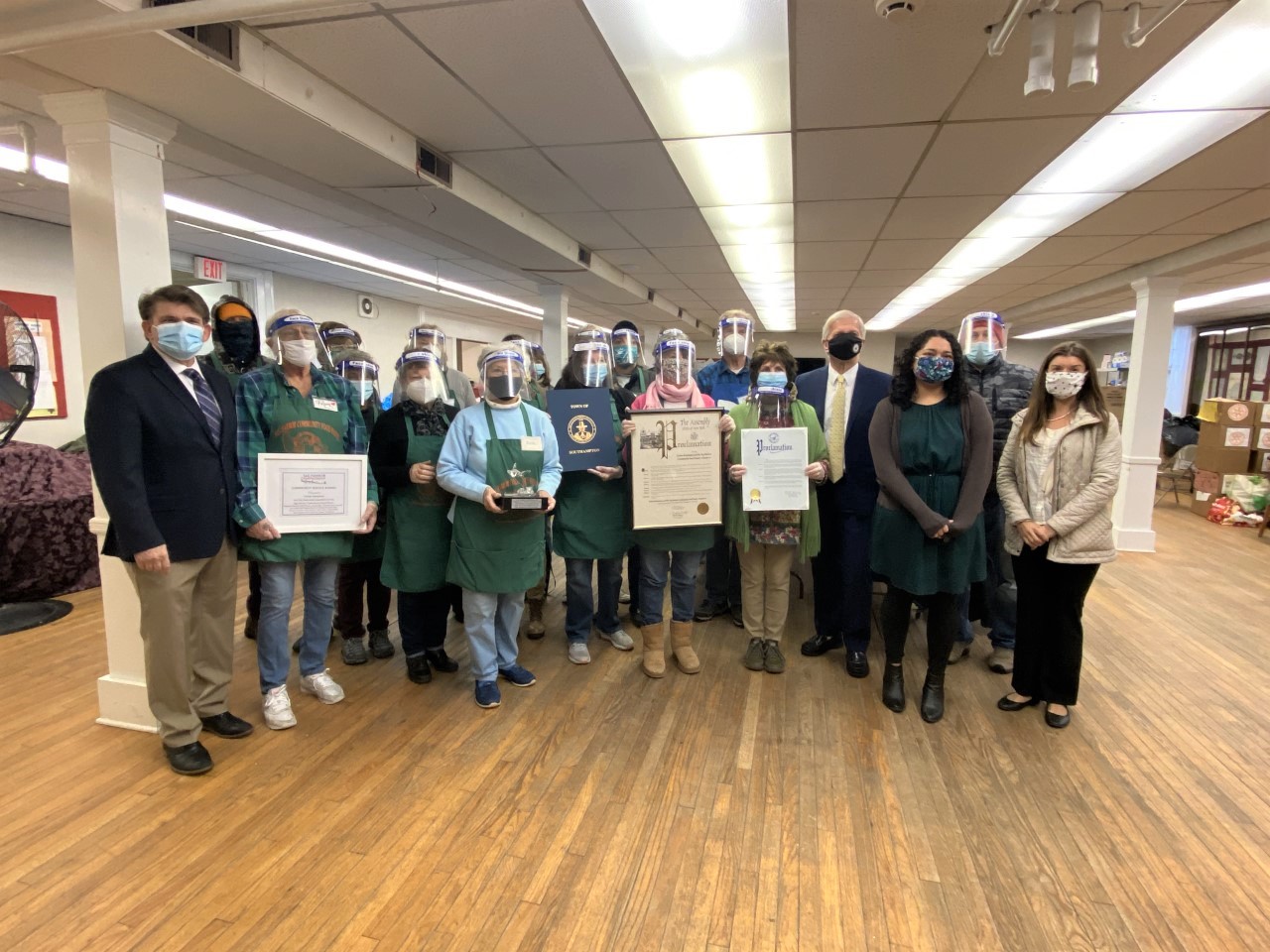 Evie Rammuno and fellow Sag Harbor Community Food Pantry volunteers receiving the Community Service Award and certificates of recognition.