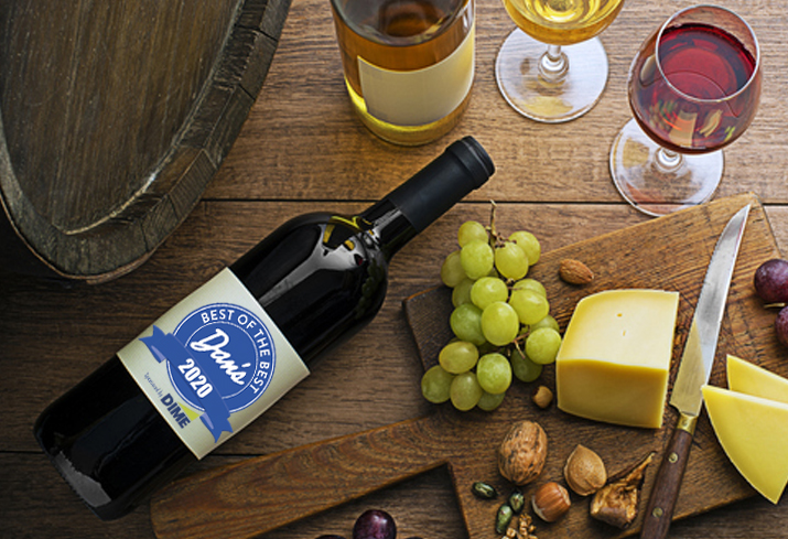 Glasses and bottles of red wine and white wine on wooden background