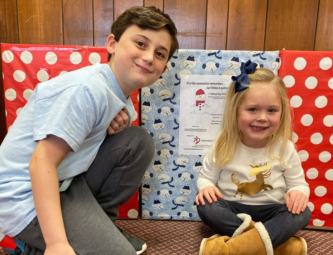 Two CHD warriors, Aidan and Clare, helping to gather and sort toys for the Mended Little Hearts of Long Island Toy Drive.