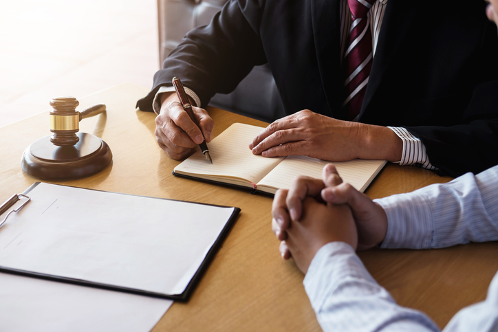 Close up of gavel, Male lawyer or judge Consult with client and working with Law books, report the case on table in modern office, Law and justice concept