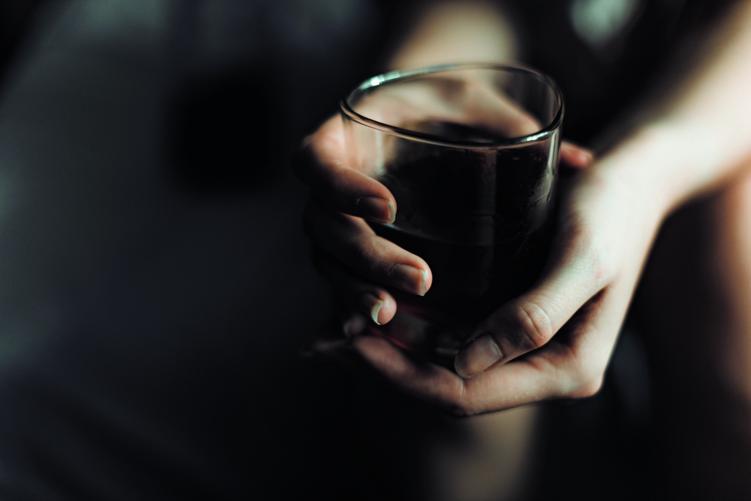 woman's hand with alcohol drink in glass with copy space