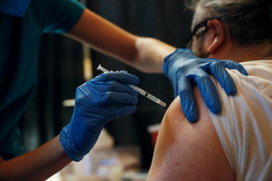 FILE PHOTO: A Metropolitan Transportation Authority (MTA) worker receives the Pfizer COVID-19 vaccination for MTA employees at Vanderbilt Hall at Grand Central Terminal  in the Manhattan borough of New York