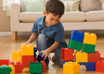 Hispanic boy playing with building blocks