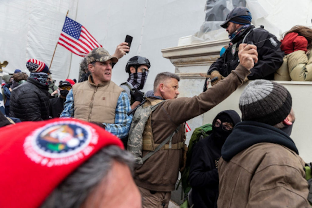 This image, included in federal investigators' criminal complaint, shows Proud Boy Christopher John Worrell allegedly spraying pepper spray gel at Capitol officers during the January 6 riot