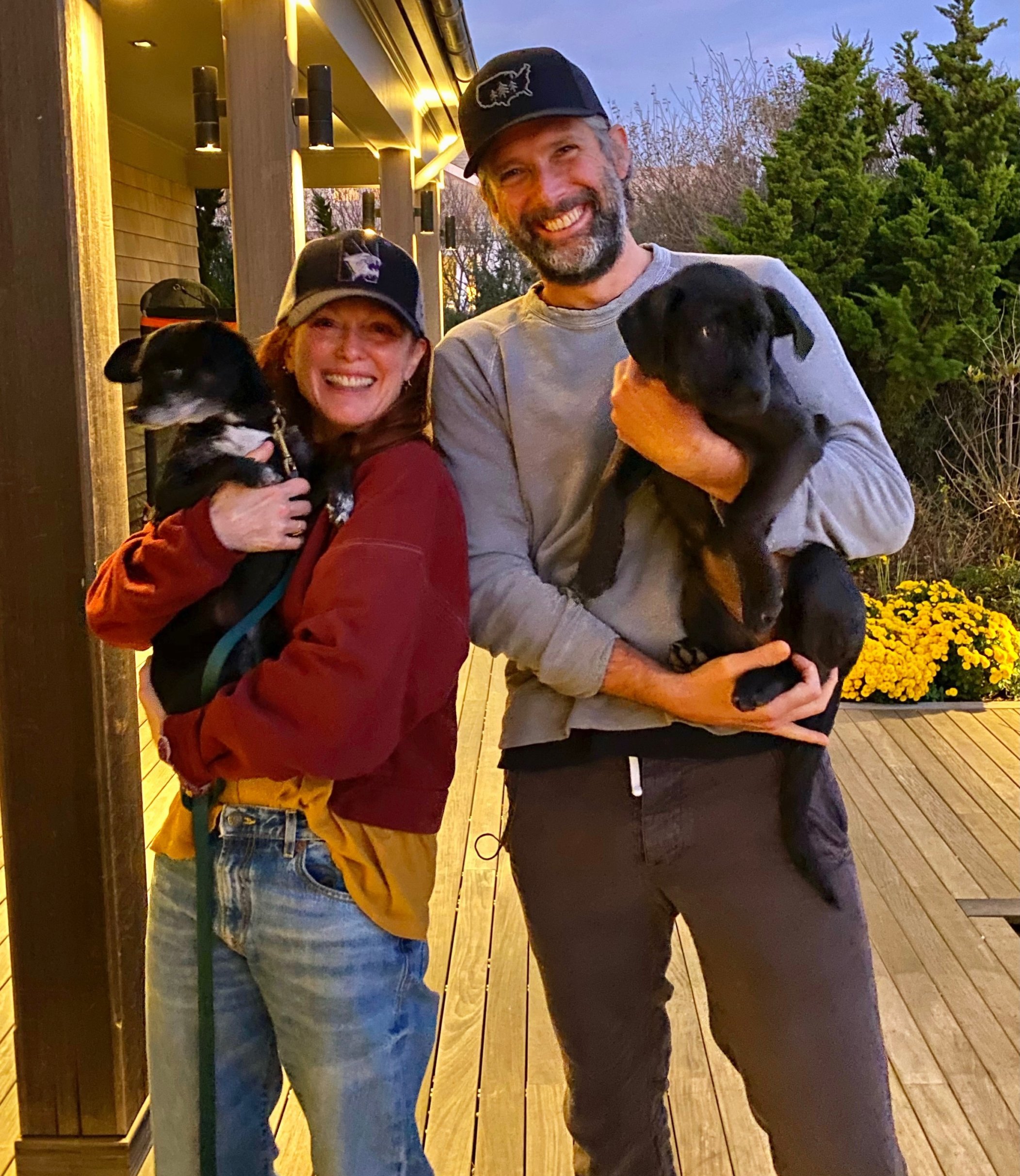 Julianne Moore holding her dog Milly and her husband Bart Freundlich holding Hope, the dog they adopted from Gimme Shelter.