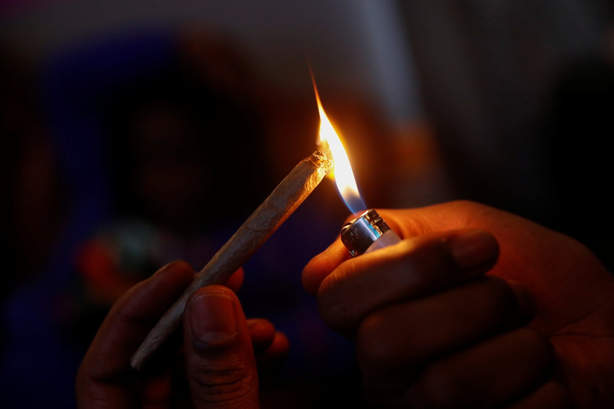 Cannabis entrepreneur Fetti lights a hybrid strain joint of his marijuana brand "PowerPuff" at a home in New York, U.S. April 1, 2021.