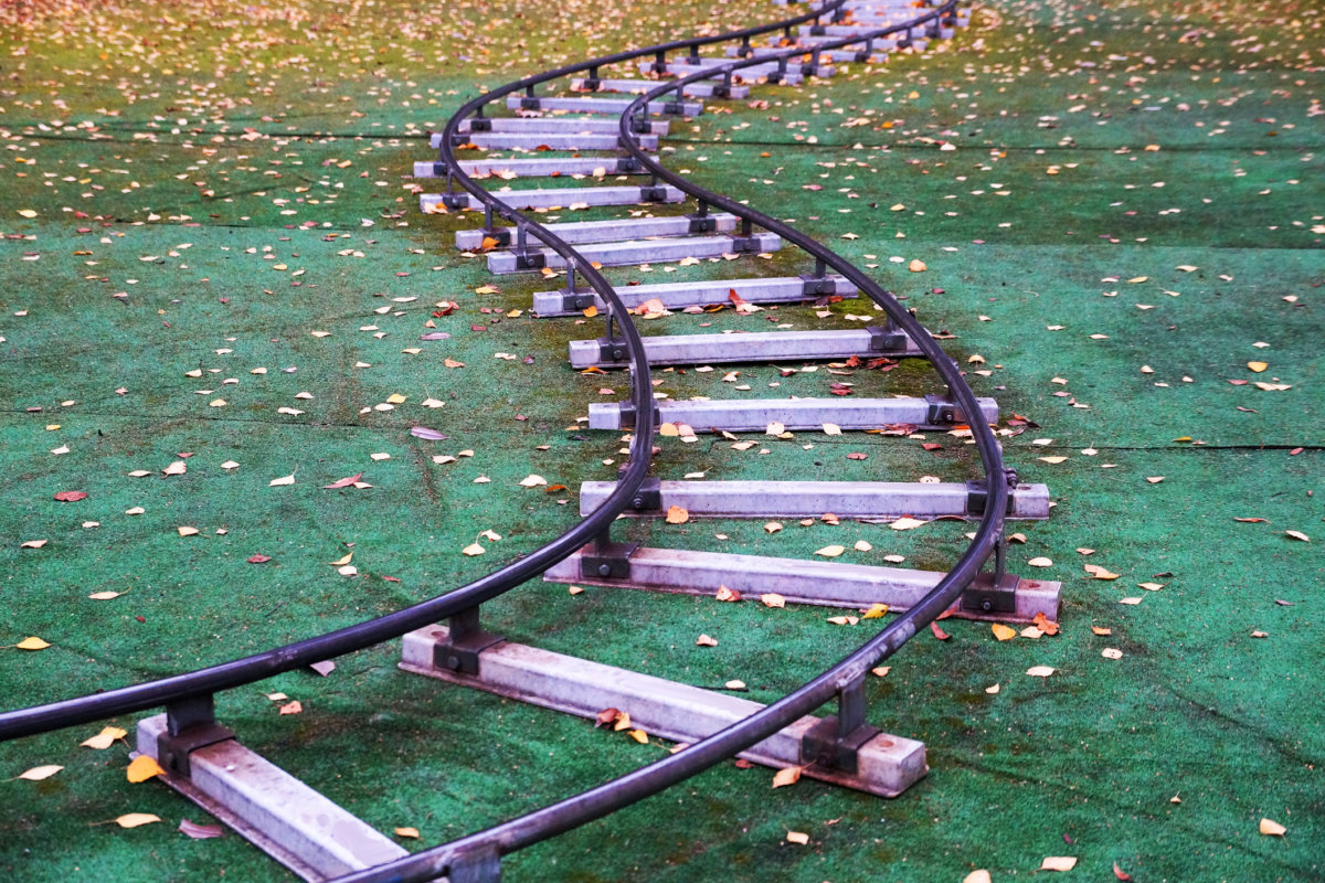children’s railway on artificial lawn in an autumn park