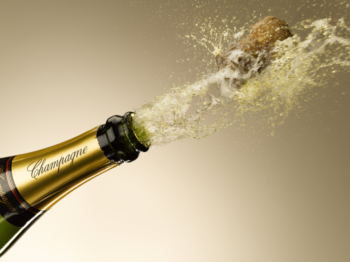 Champagne and cork exploding from bottle north fork