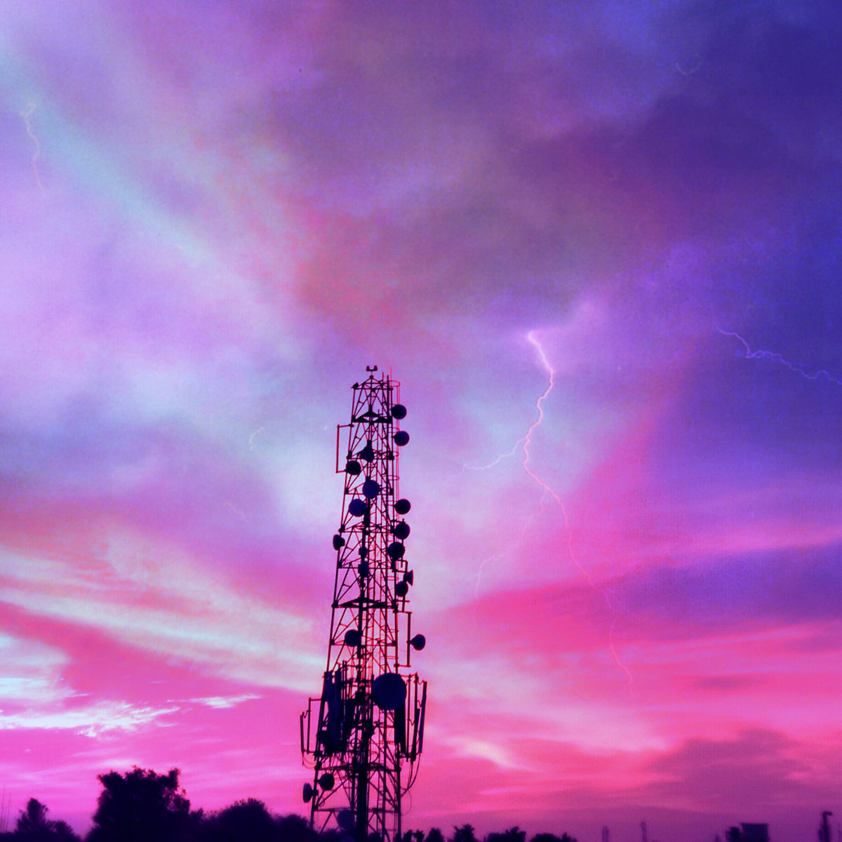 Low Angle View Of Communications Tower Against Dramatic Sky