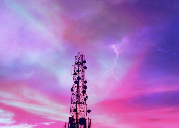 Low Angle View Of Communications Tower Against Dramatic Sky