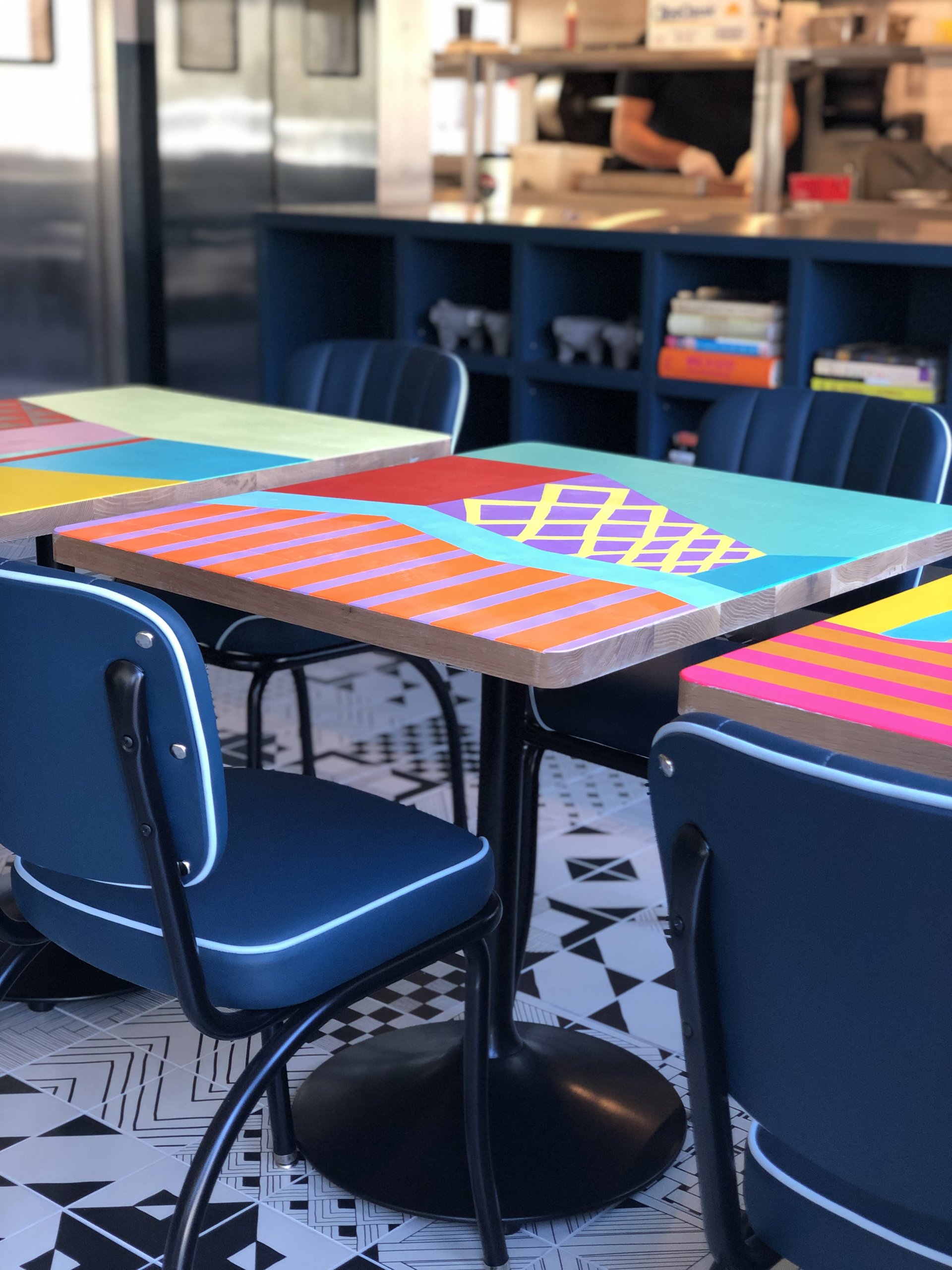 The artist-designed table tops at Coche Comedor