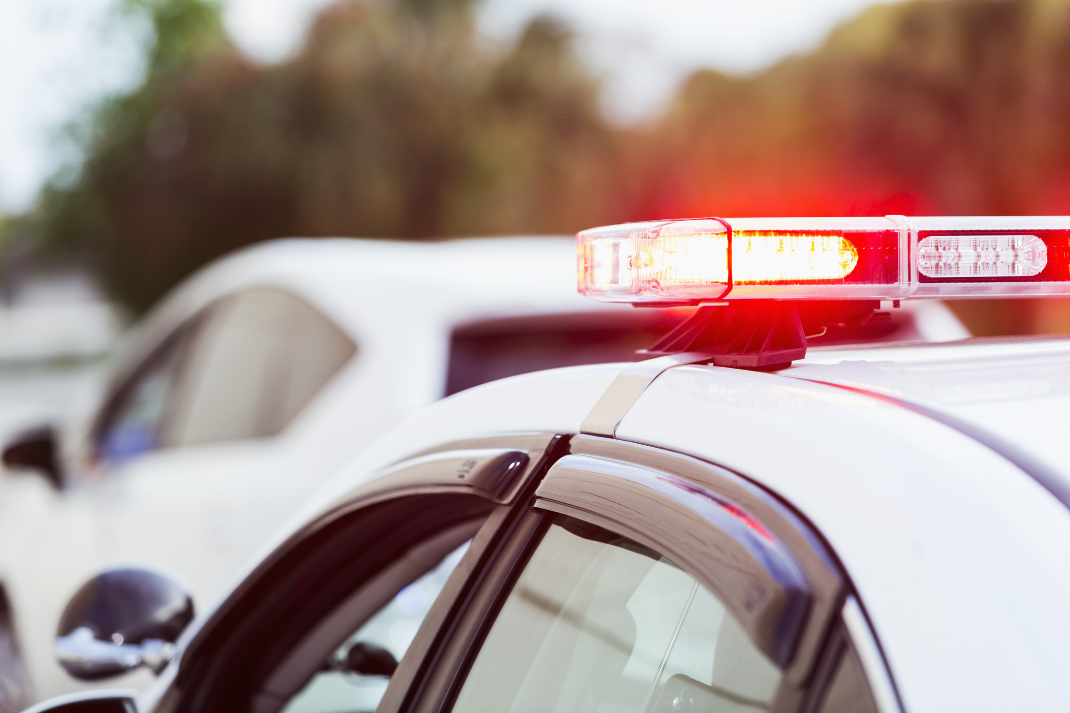 Police car with lights flashing making traffic stop