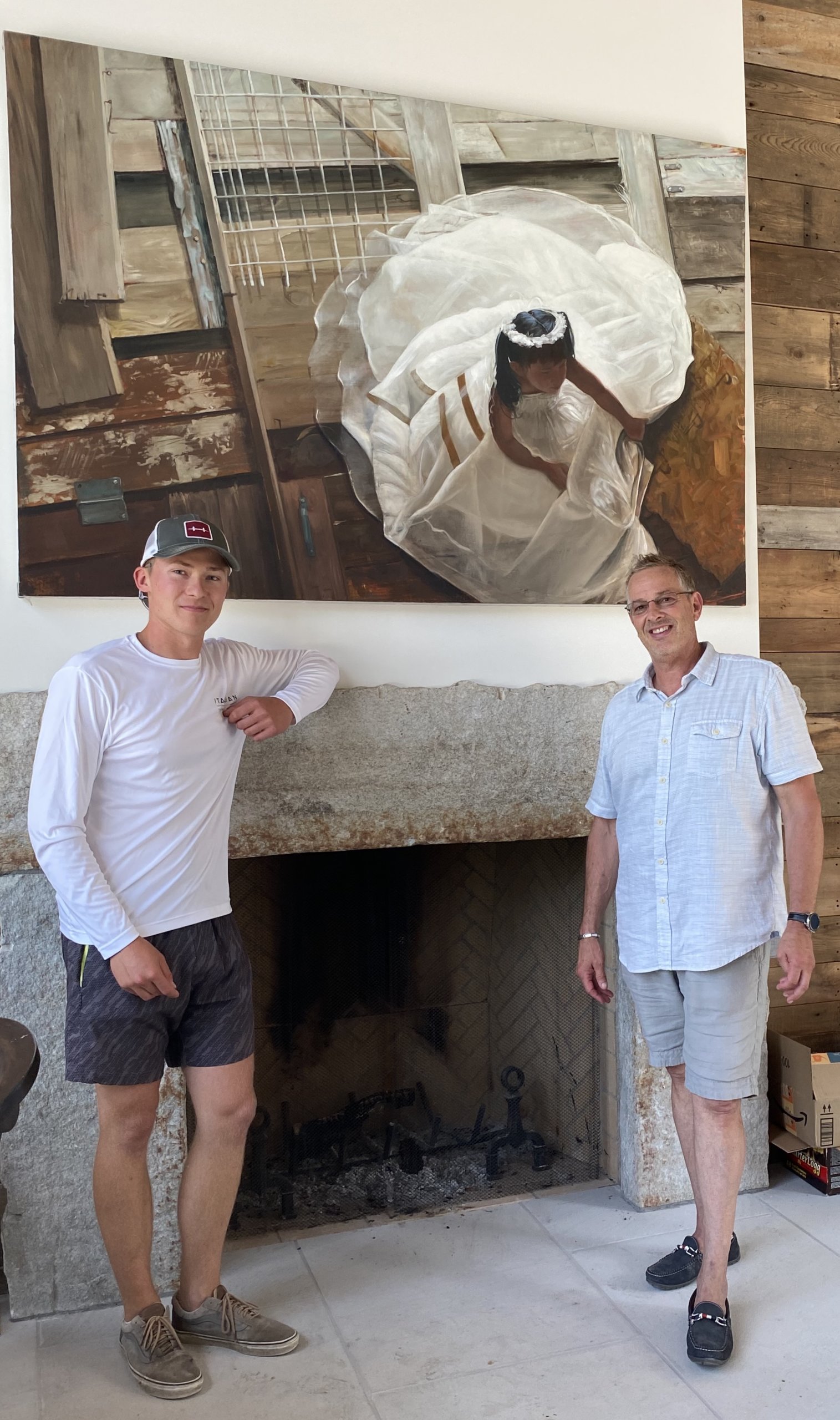 Jon Tibett with his son Krystian in front of one of the many pieces of art found all over his properties.