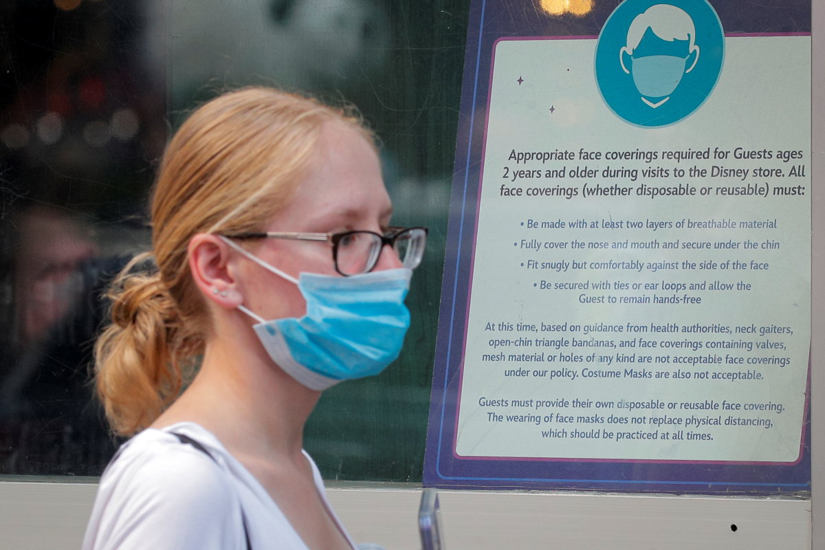 A woman wears a mask against COVID-19, following the CDC recommendation to protect against the Delta variant