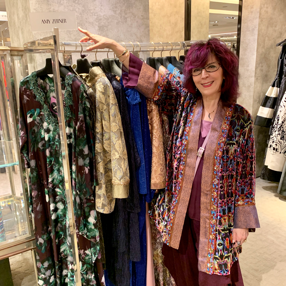 Amy Zerner with rack of her designs