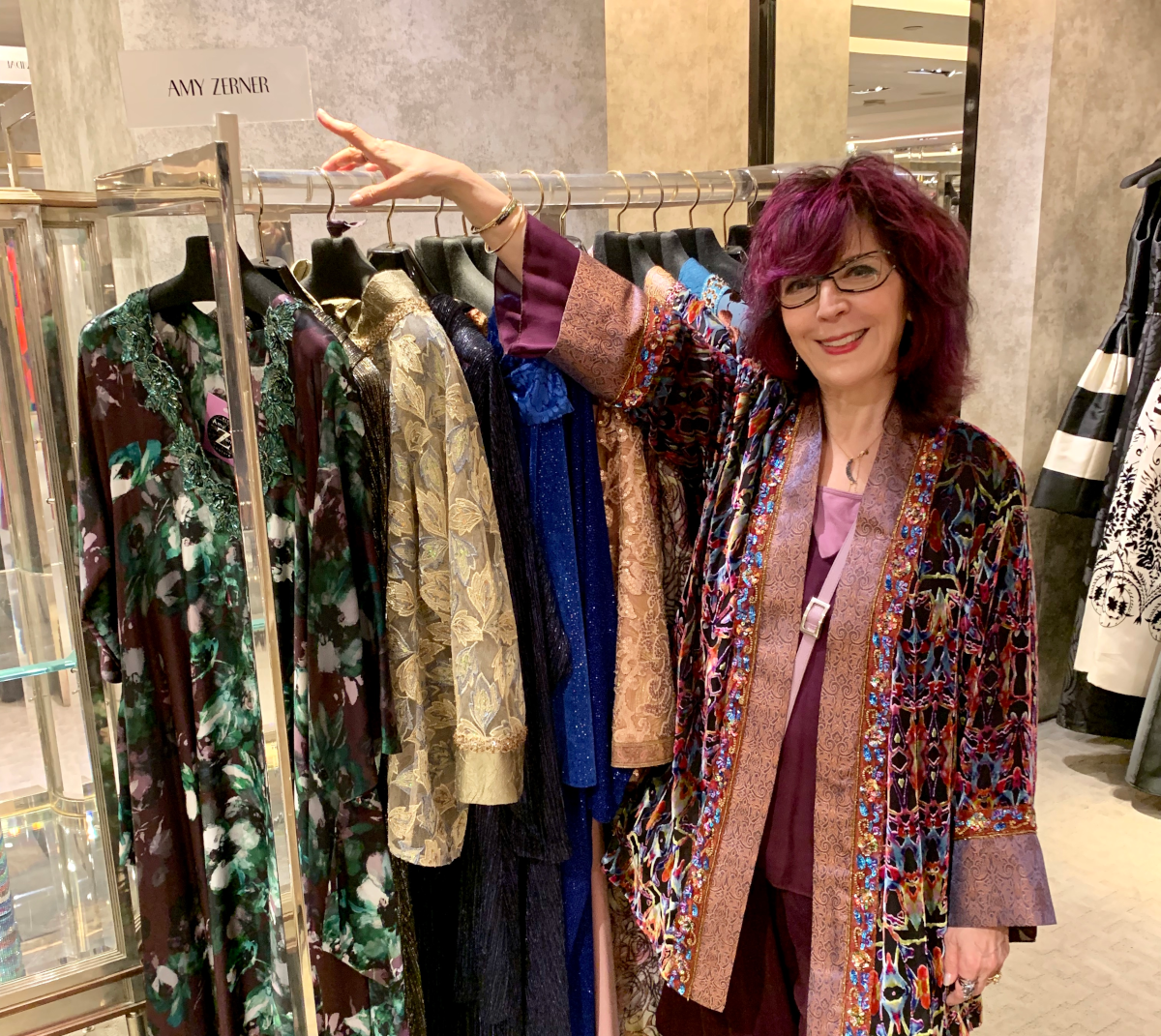 Amy Zerner with rack of her designs