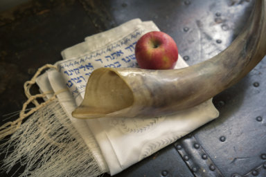 Shofar, Jewish prayer shawl (TALIT) and apple. Yom Kippur, Rosh Hashanah for atonement