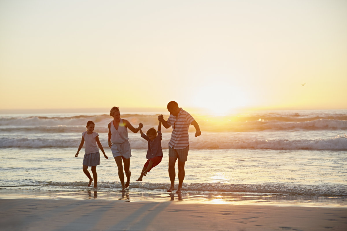 Parents with children enjoying vacation on beach