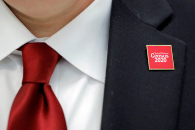 A United States Census 2020 pin is worn by Jeff T. Behler, Regional Director at the New York Regional Census Center, at an event where U.S. Rep. Alexandria Ocasio-Cortez (D-NY) spoke at a Census Town Hall at the Louis Armstrong Middle School in Queens, New York City, U.S., February 22, 2020. REUTERS/Andrew Kelly