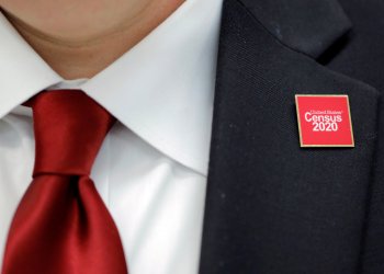 A United States Census 2020 pin is worn by Jeff T. Behler, Regional Director at the New York Regional Census Center, at an event where U.S. Rep. Alexandria Ocasio-Cortez (D-NY) spoke at a Census Town Hall at the Louis Armstrong Middle School in Queens, New York City, U.S., February 22, 2020. REUTERS/Andrew Kelly