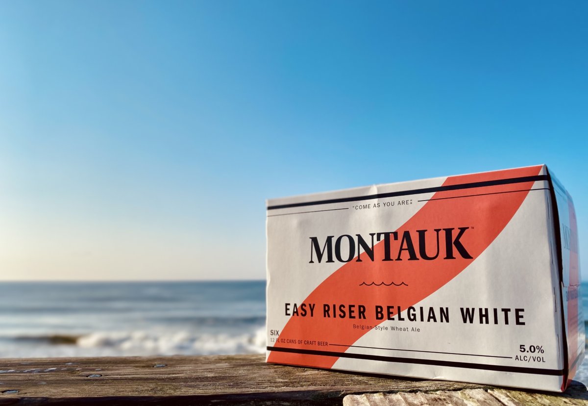 Case of Montauk Brewing Co. Easy Riser Belgian White beer by the ocean