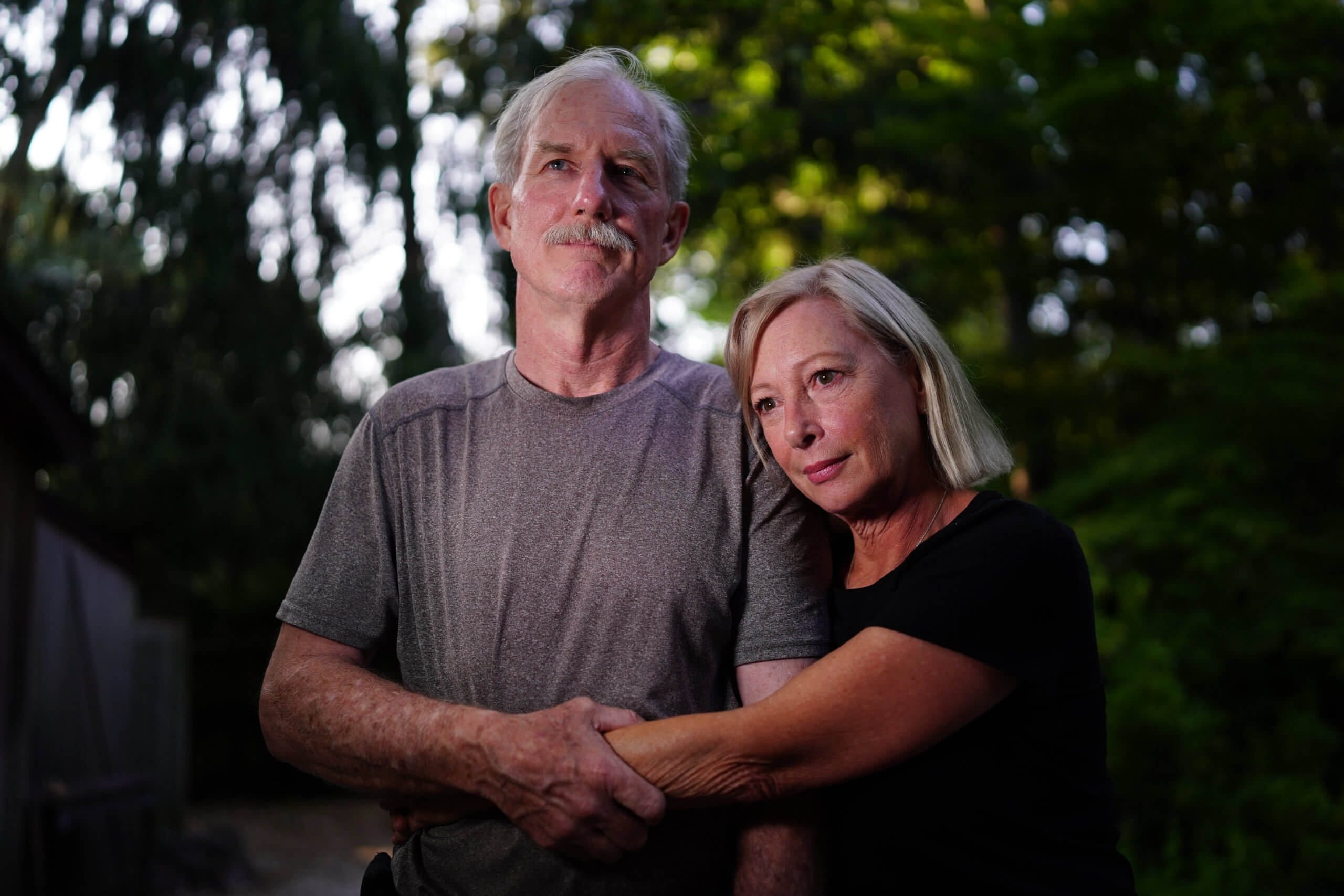 FDNY Lt. Raymond Brown hugs his wife Karen Kluglein, August 29, 2021 in Sag Harbor, N.Y. Approaching the 20th anniversary of Sept. 11 he recalls how he survived the terrorist attack at the World Trade Center. ‘This helmet saved my life. Debris hit the back of my head knocking me out. It was almost 344.’ Referring to the 343 firefighters killed that day.