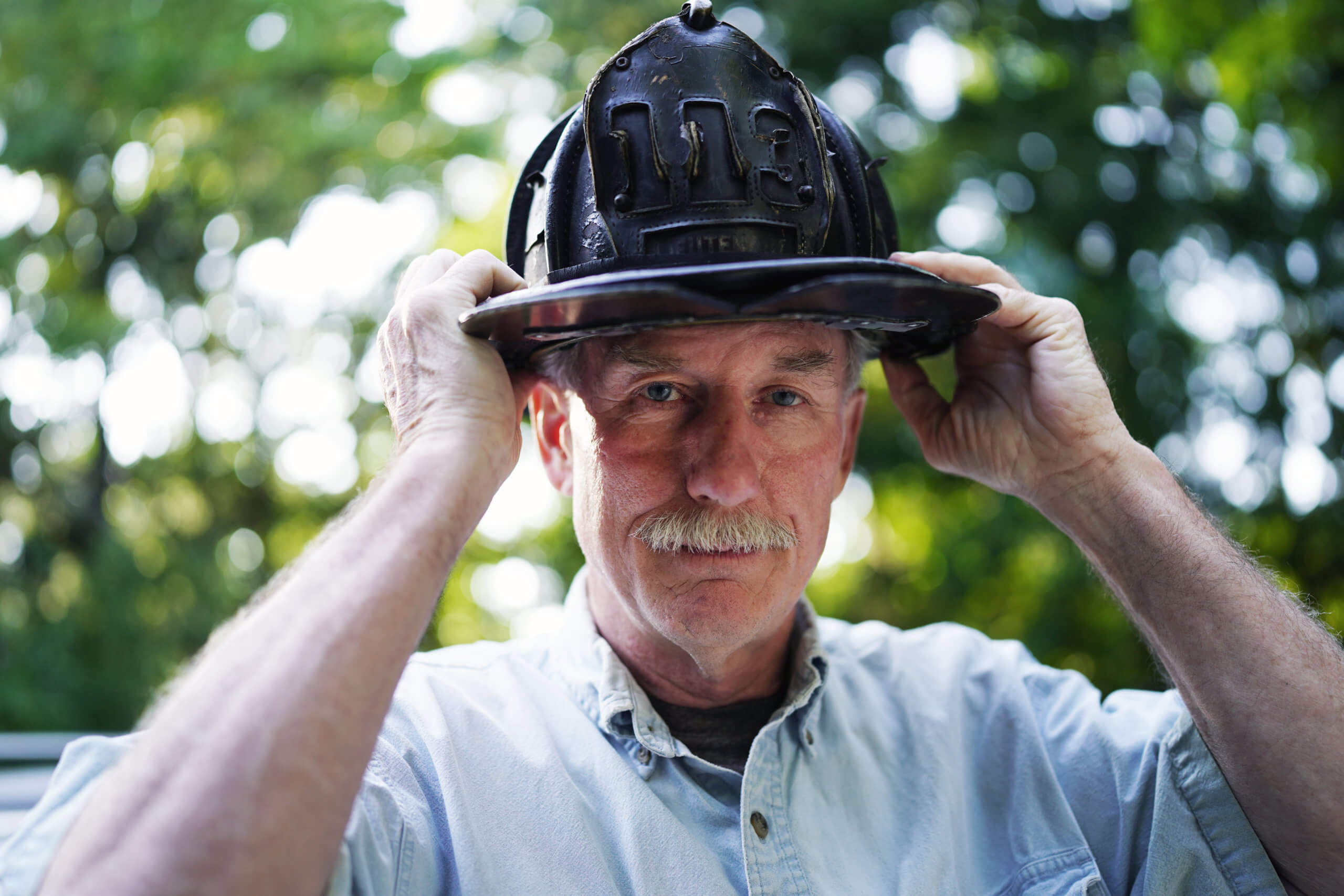 FDNY Lt. Raymond Brown, August 29, 2021 in Sag Harbor, N.Y. Approaching the 20th anniversary of Sept. 11 he recalls how he survived the terrorist attack at the World Trade Center. ‘This helmet saved my life. Debris hit the back of my head knocking me out. It was almost 344.’ Referring to the 343 firefighters killed that day.