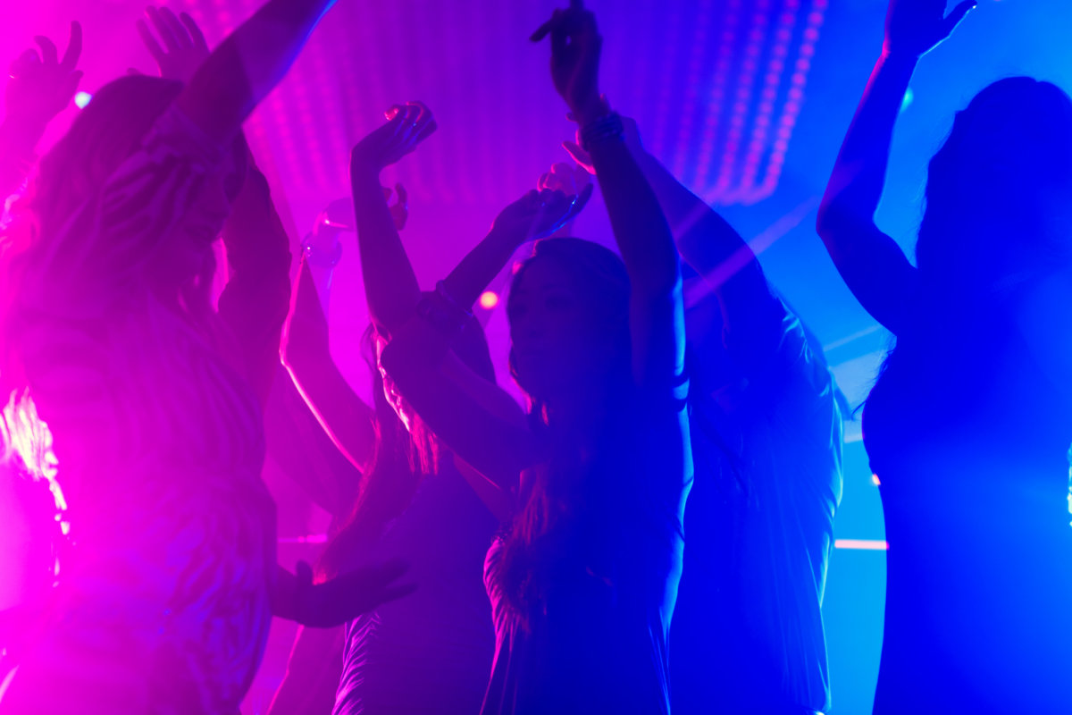 Party people dancing in disco club