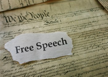 Learn your rights - Free Speech newspaper headline on a copy of the United States Constitution