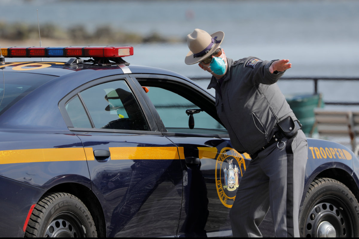 A New York State Police officer works at the check point at a testing facility for coronavirus in New Rochelle, Westchester County, New York