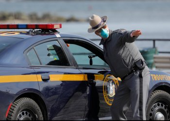 A New York State Police officer works at the check point at a testing facility for coronavirus in New Rochelle, Westchester County, New York