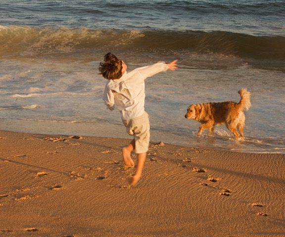 Photo of child and dog on Hamptons beach by Lucille Khornak
