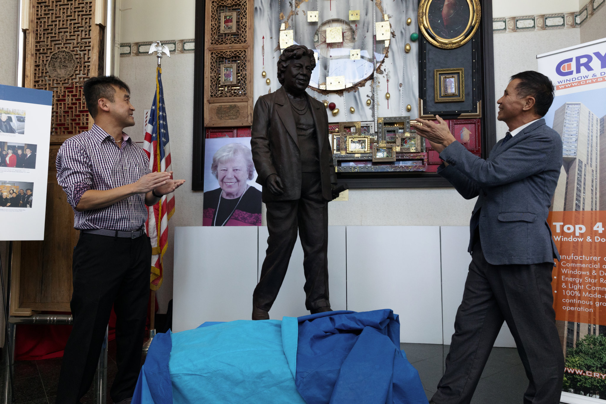 Steve Chen, left, and Thomas Chen unveil a statue of former Queens Borough President Claire Shulman on Thursday, Oct. 7, 2021.